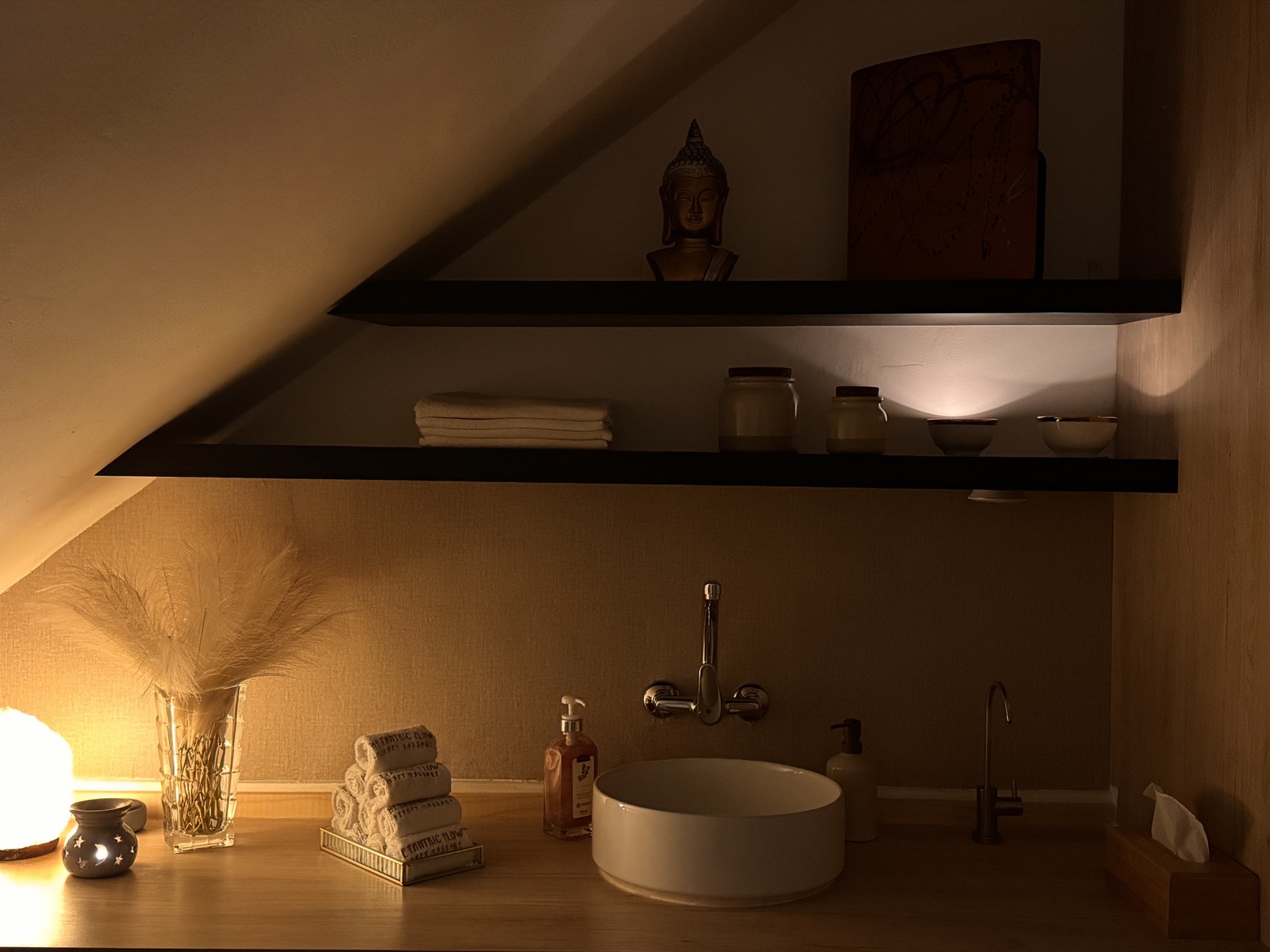 Zen washbasin with amenities and towels at The Tantric Flow in Lisbon